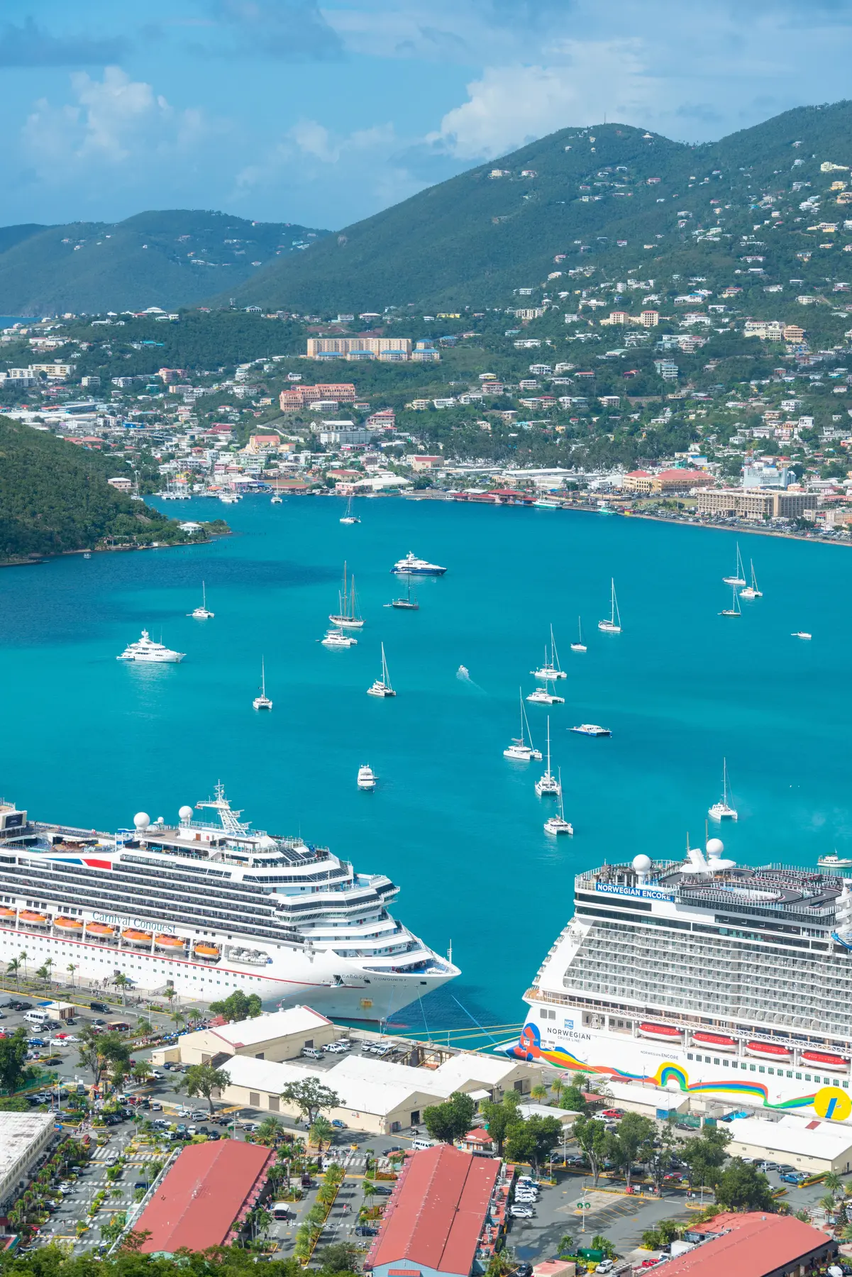 Two ocean cruise ships beside brilliant turquoise water