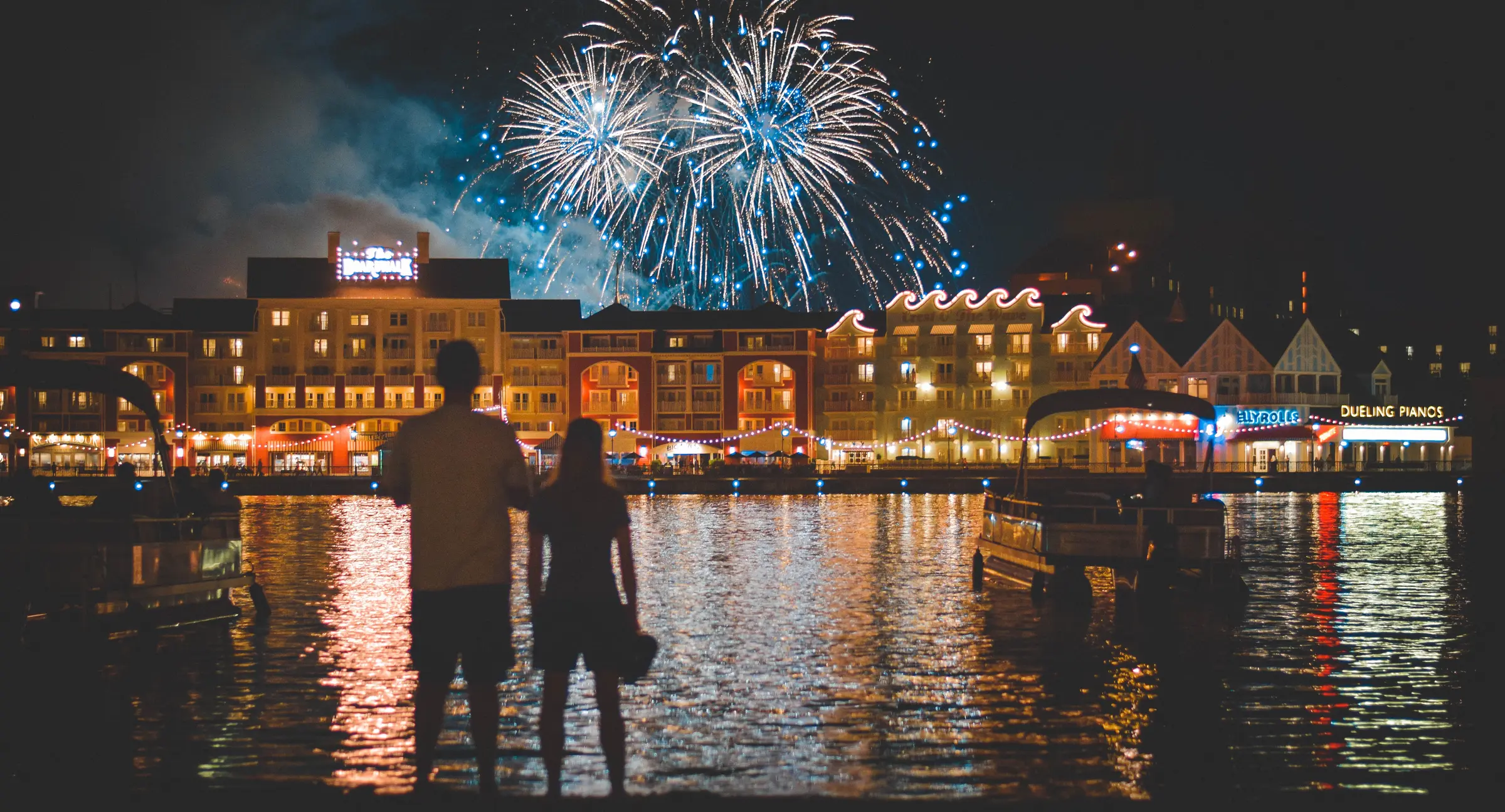 Disney's BoardWalk glowing beneath fireworks