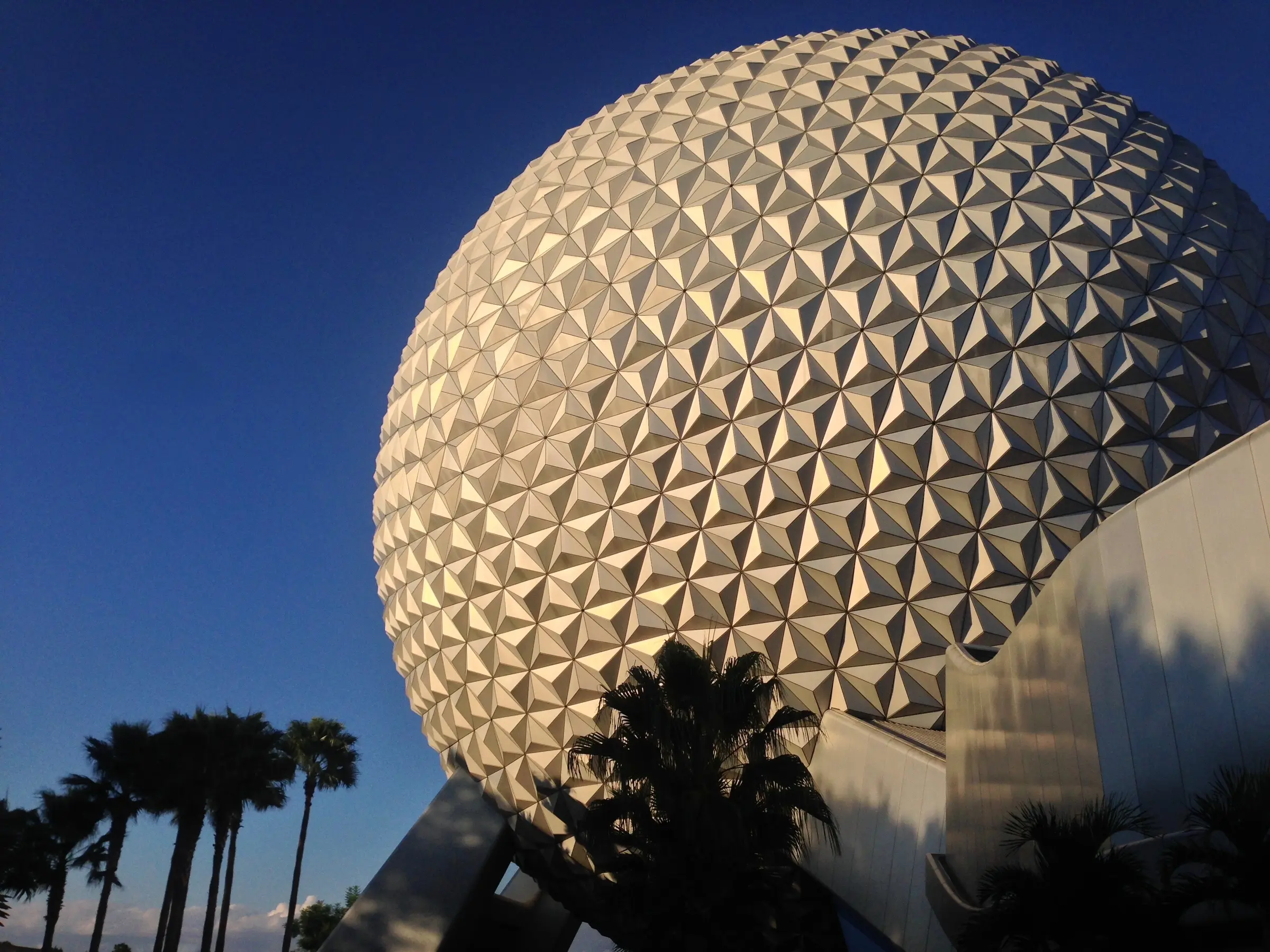 Spaceship Earth rising above the palms at EPCOT