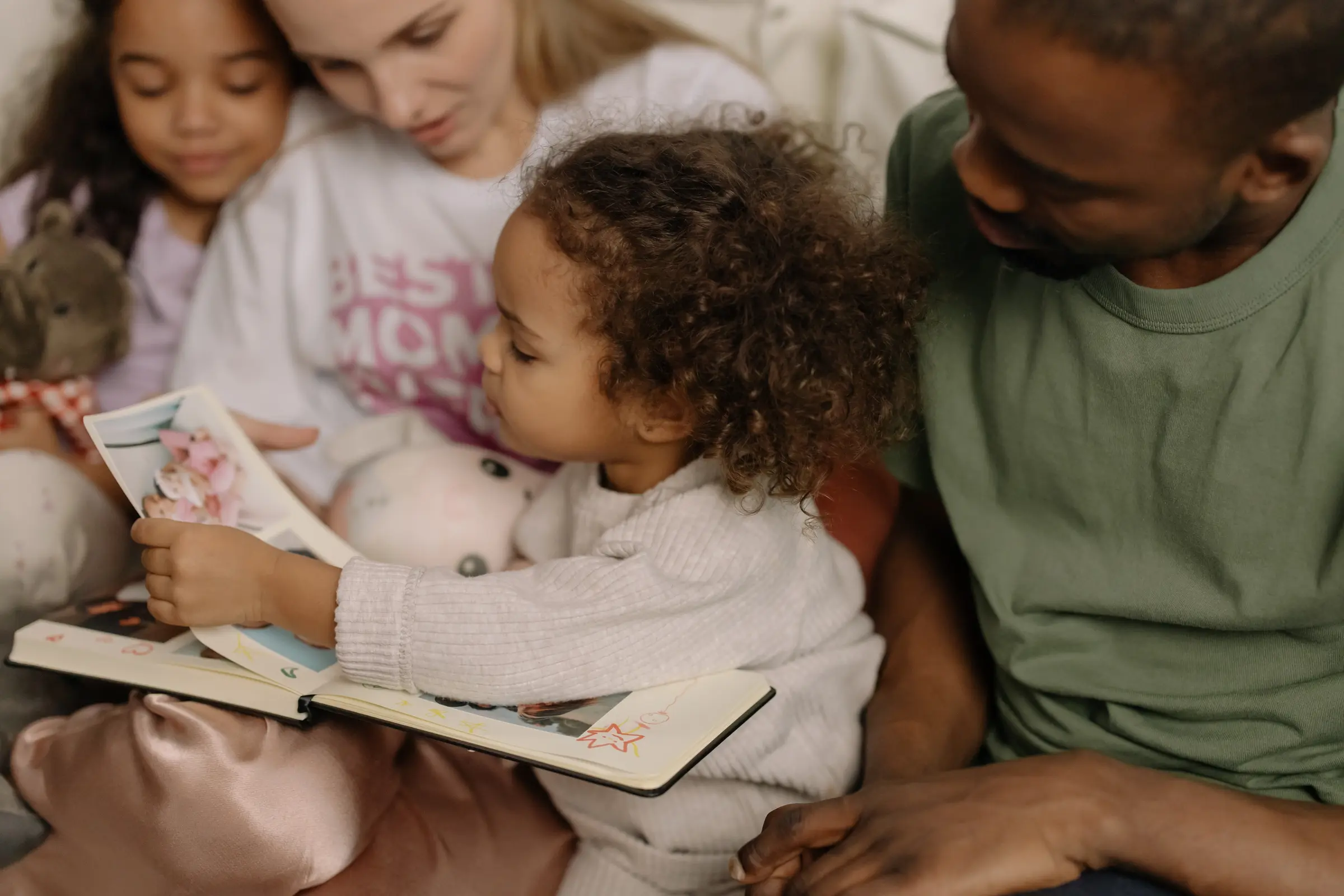 A family looking through an album of photographs together