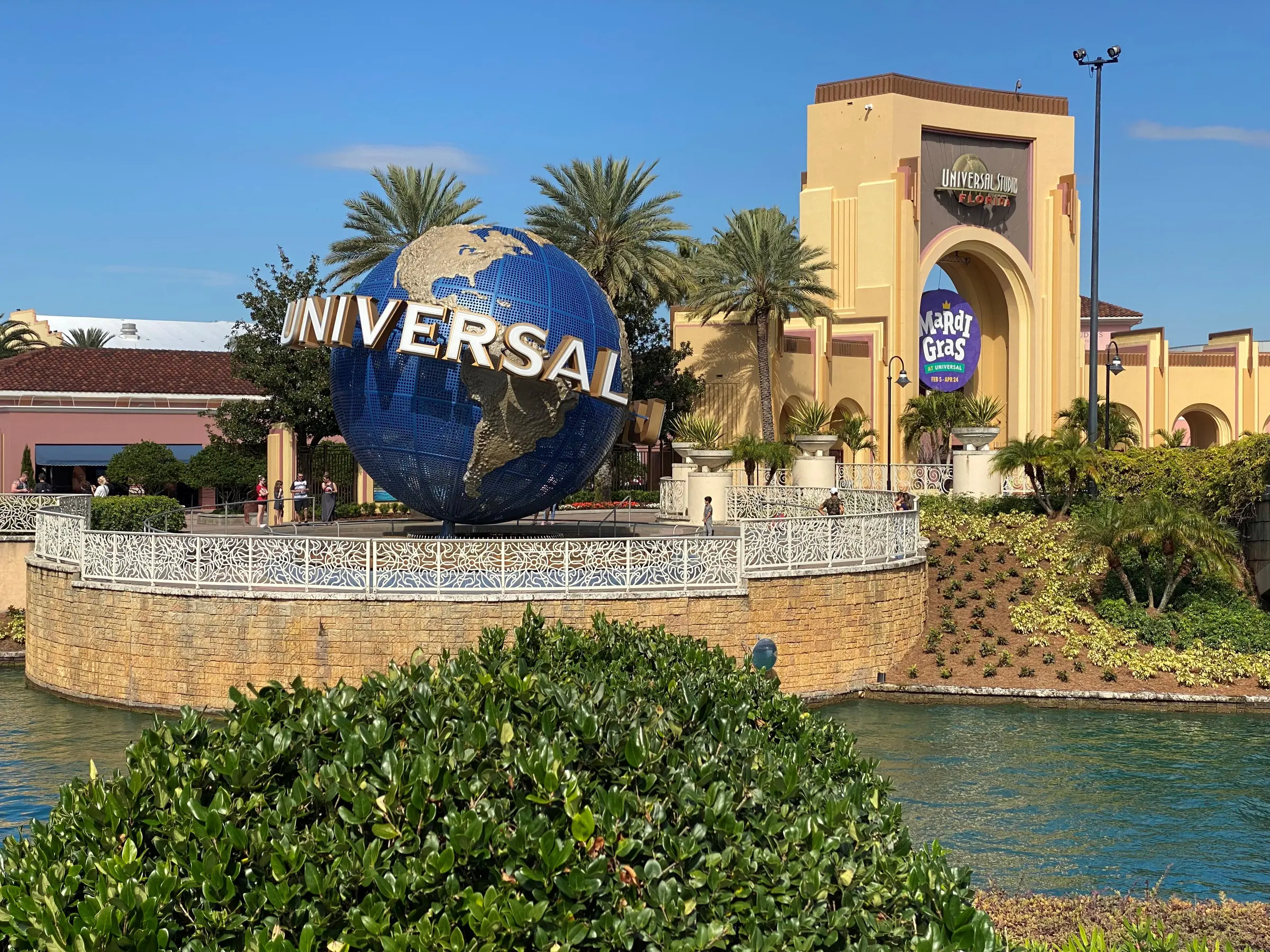 Universal Orlando globe and park entrance beneath a bright blue sky